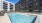 a swimming pool in a courtyard between buildings