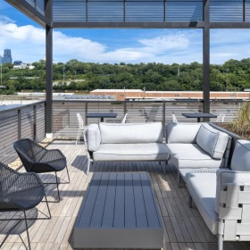 Settle into comfort at The Yards Apartments a deck with chairs and a table