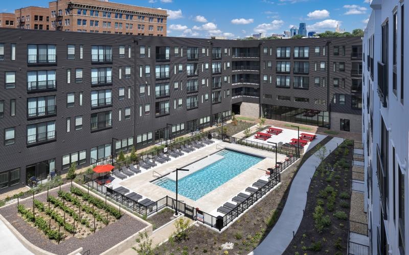 a pool in a courtyard between buildings