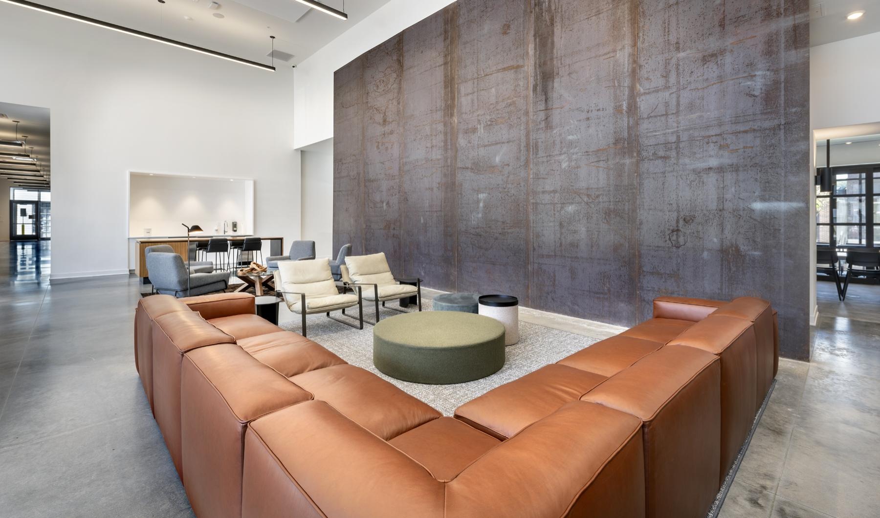 a room with a couch and chairs