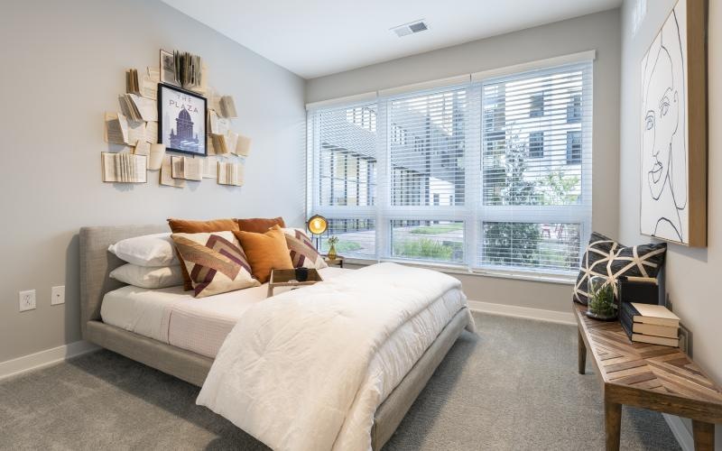 a bedroom with a large window