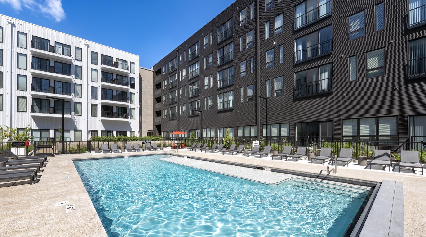 a swimming pool in a courtyard between buildings