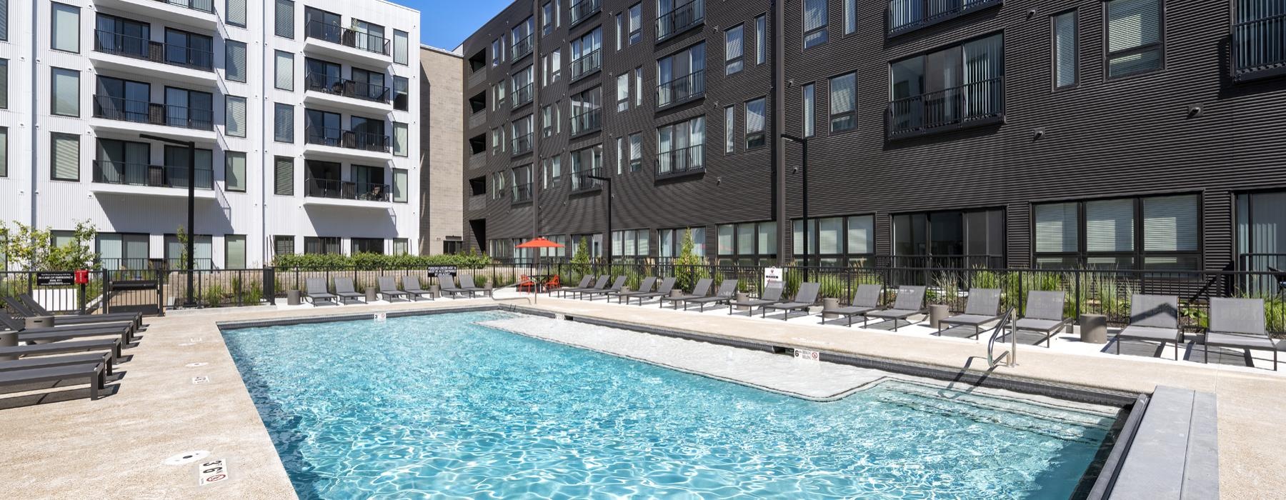 a swimming pool in a courtyard between buildings